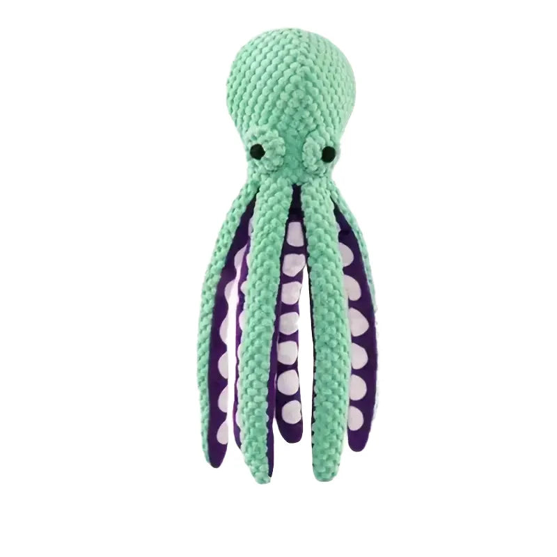 Green and purple knitted octopus toy on a white background